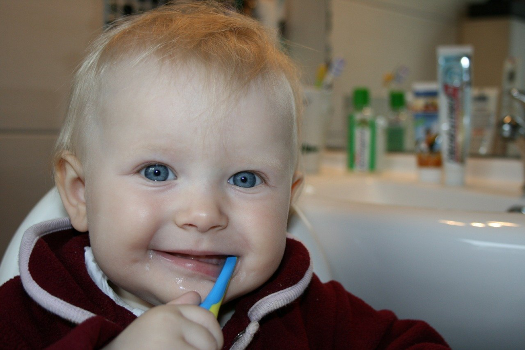 Happy baby with toothbrush